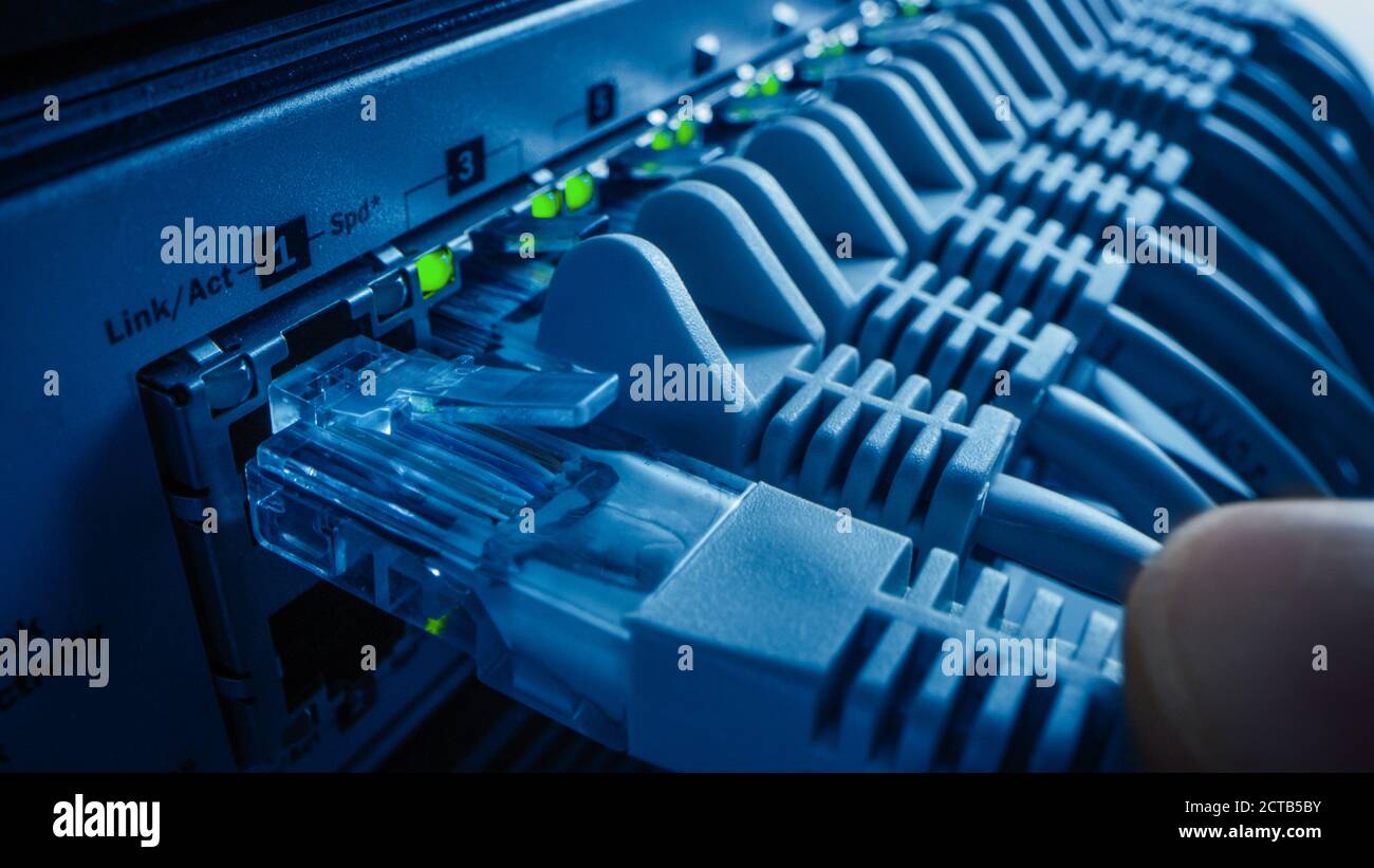 Close Up Macro Shot Person Plugs In Rj45 Internet Connector Into Lan Router Switch Information Communication Network With Data Cable Being Connected Stock Photo Alamy