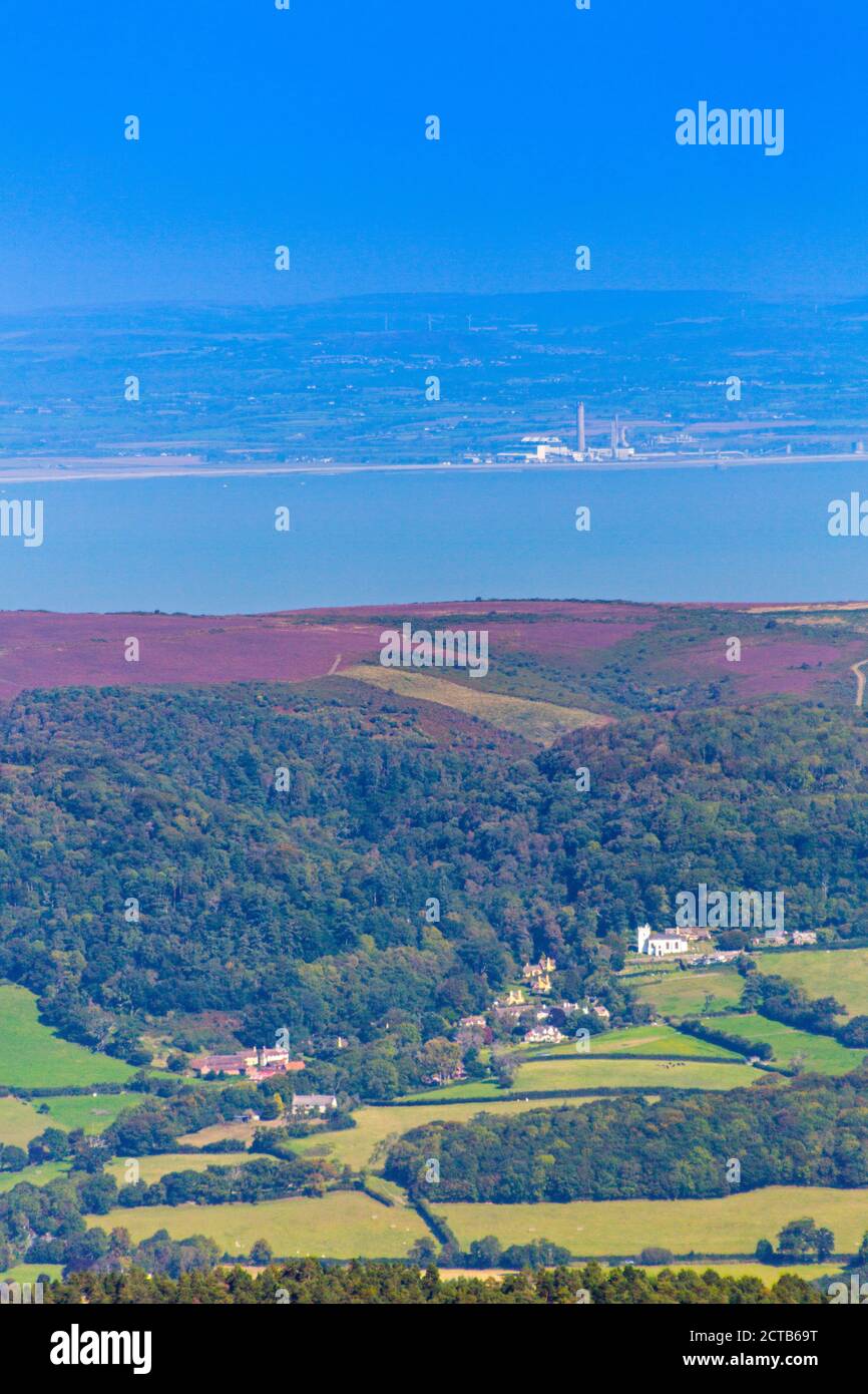 View from the summit of Dunkery Beacon (1,705ft) over the Bristol Channel and Selworthy village to Welsh coastline from Exmoor, Somerset, England, UK Stock Photo