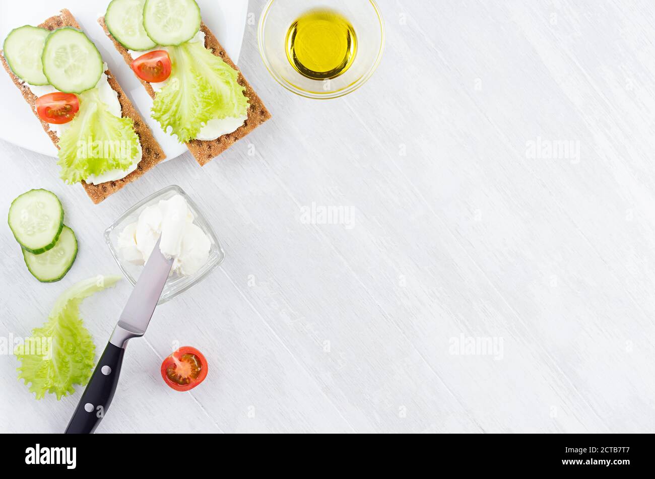 Cooking of fresh light summer appetizer of crisps bread, green salad