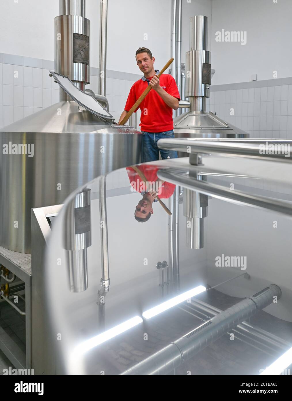 Bernau, Germany. 21st Sep, 2020. Ruslan Hofmann, brewing engineer from the Erste Bernauer Braugenossenschaft e.G. stands between the brewing and fermentation tanks in the brewery in the Börnicke district. Bernau was once famous for its black beer. A good 100 years ago, that ended - until now. The newly founded First Bernau Brewery Cooperative and the town benefit from each other on the old Börnicke estate. And the regional brew goes down well, just like in the old days. Credit: Patrick Pleul/dpa-Zentralbild/ZB/dpa/Alamy Live News Stock Photo