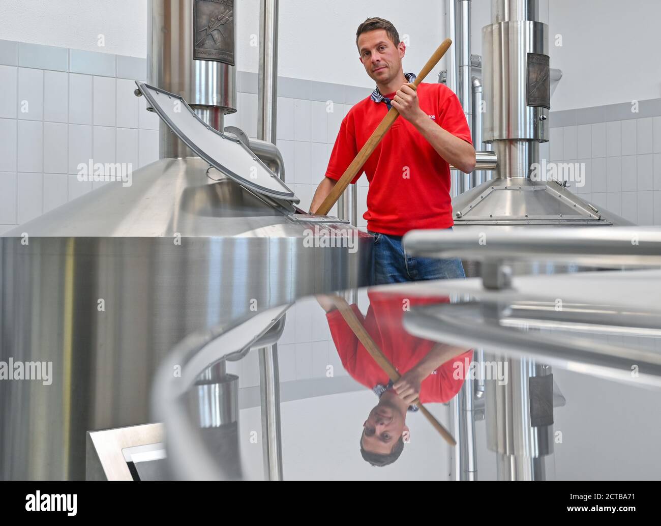 Bernau, Germany. 21st Sep, 2020. Ruslan Hofmann, brewing engineer from the Erste Bernauer Braugenossenschaft e.G. stands between the brewing and fermentation tanks in the brewery in the Börnicke district. Bernau was once famous for its black beer. A good 100 years ago, that ended - until now. The newly founded First Bernau Brewery Cooperative and the town benefit from each other on the old Börnicke estate. And the regional brew goes down well, just like in the old days. Credit: Patrick Pleul/dpa-Zentralbild/ZB/dpa/Alamy Live News Stock Photo