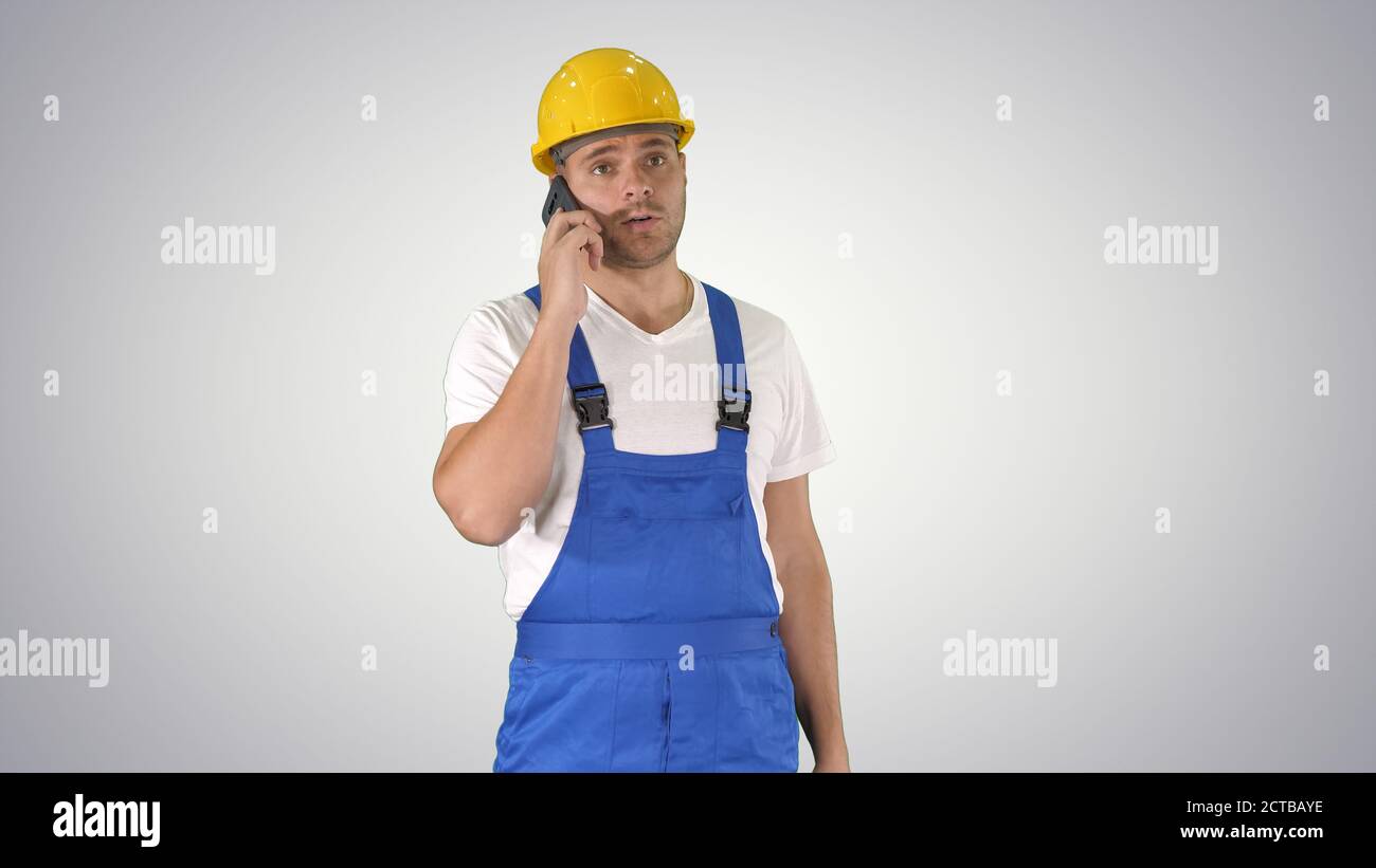 Construction Worker On Telephone on gradient background. Stock Photo