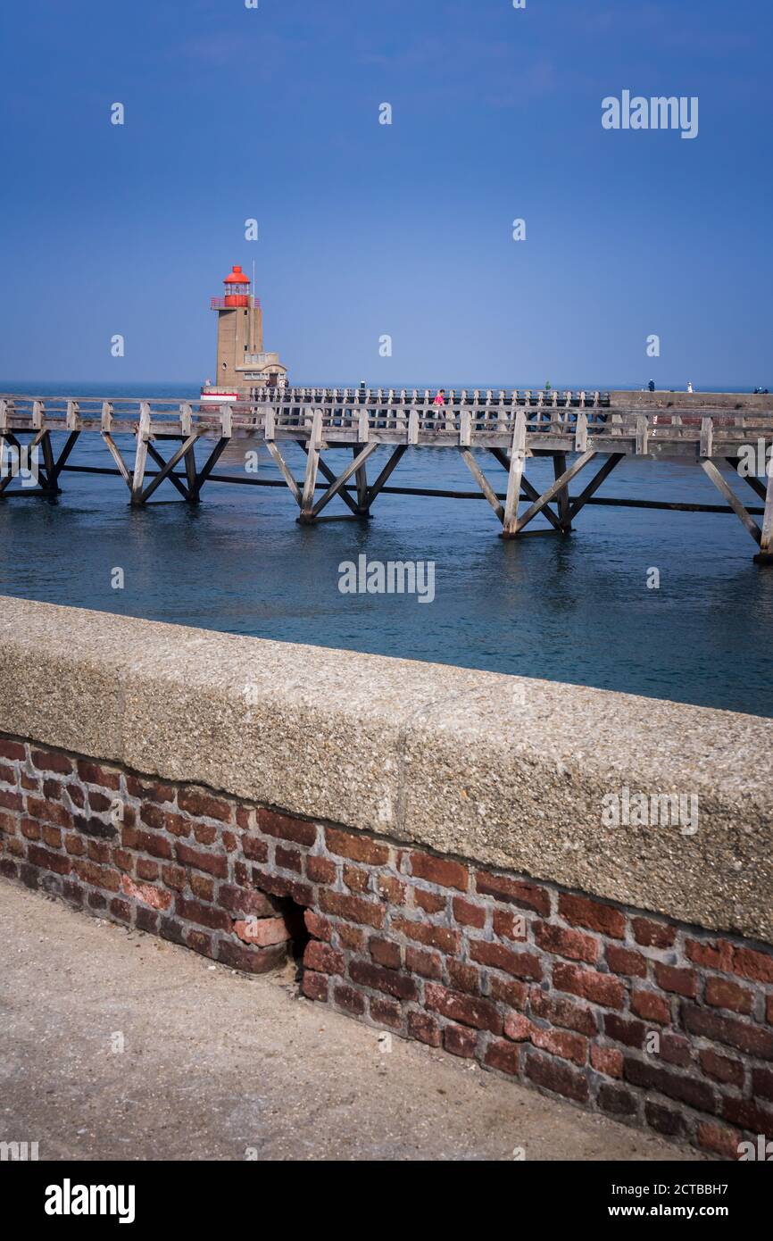 Wooden jetty and lighthouse on the harbour. The treport in Normandy Stock Photo