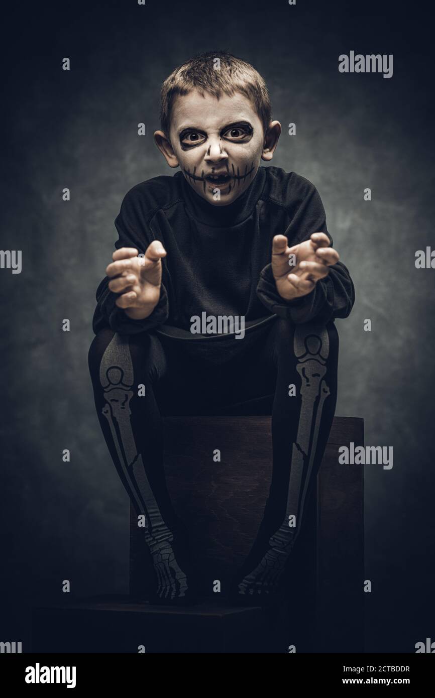 child dressed and made up as a skeleton for halloween party Stock Photo