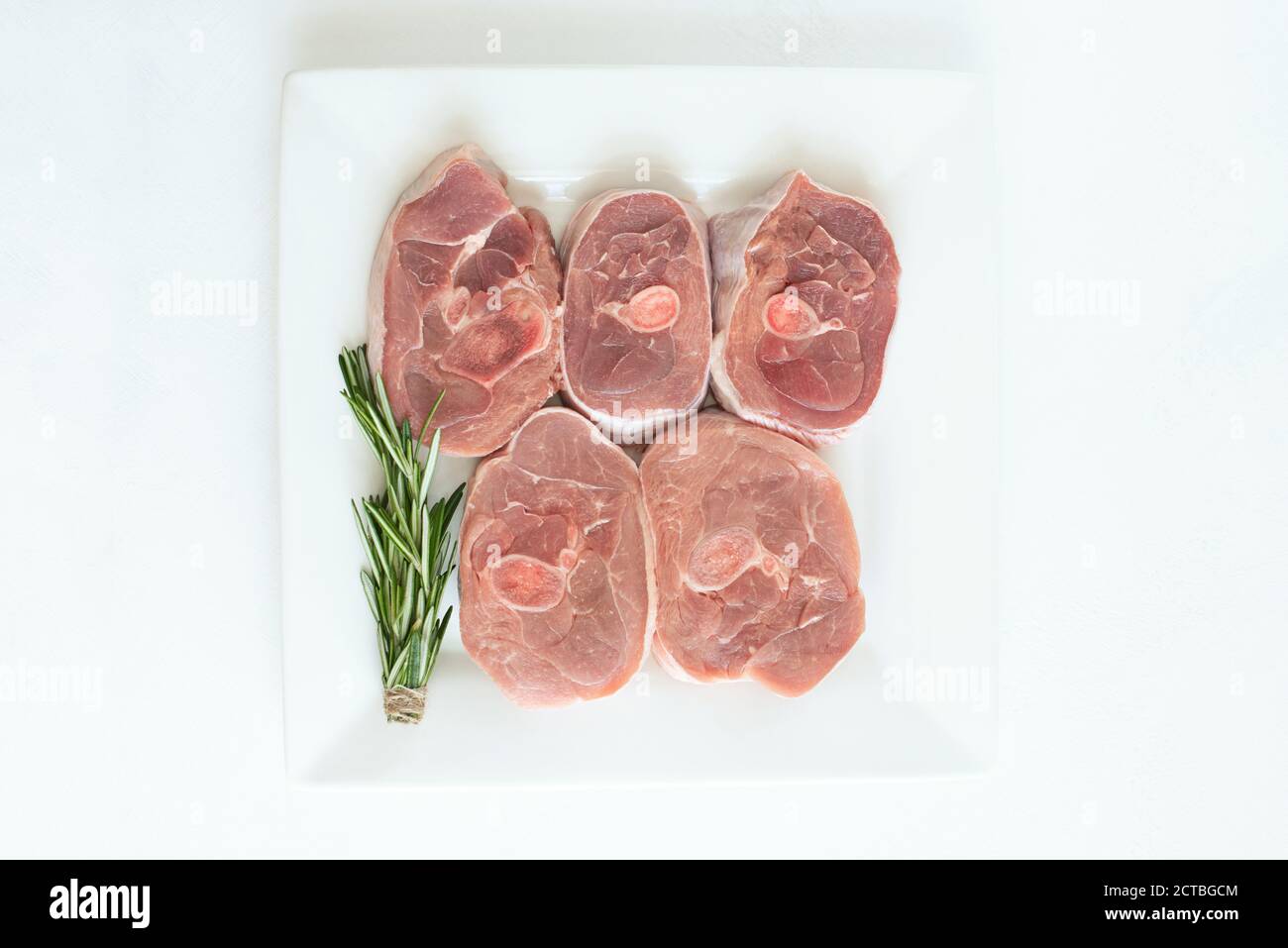 https://c8.alamy.com/comp/2CTBGCM/pieces-of-raw-turkey-meat-chopped-leg-steak-portioned-barbecue-pieces-on-white-background-with-a-sprig-of-rosemary-and-red-hot-pepper-isolate-2CTBGCM.jpg