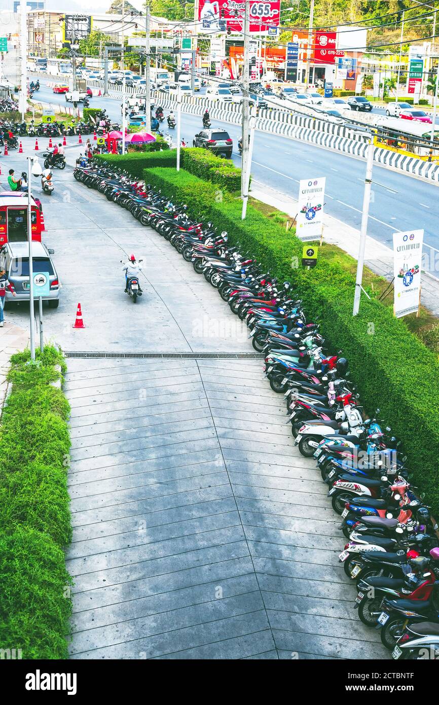 Phuket, Thailand - 26 February 2018: Many motorbikes parking, biker driving on road top view Stock Photo