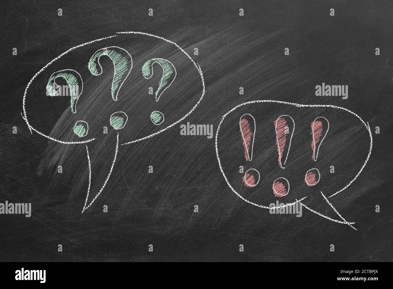 Exclamation point and question mark in speech bubbles on blackboard. Question and Answer. Consultation, support or business communication concept. Stock Photo