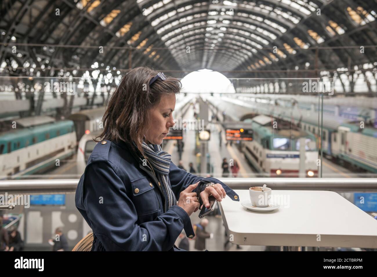 Woman Sitting in a Restaurant in Railroad Station in Milan, Italy. Stock Photo