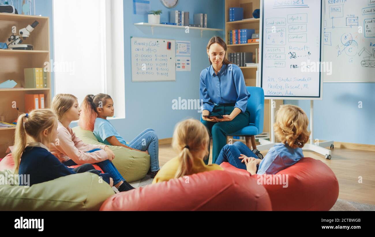 Elementary School Creativity Class: Children Sitting on the Bean Bags ...
