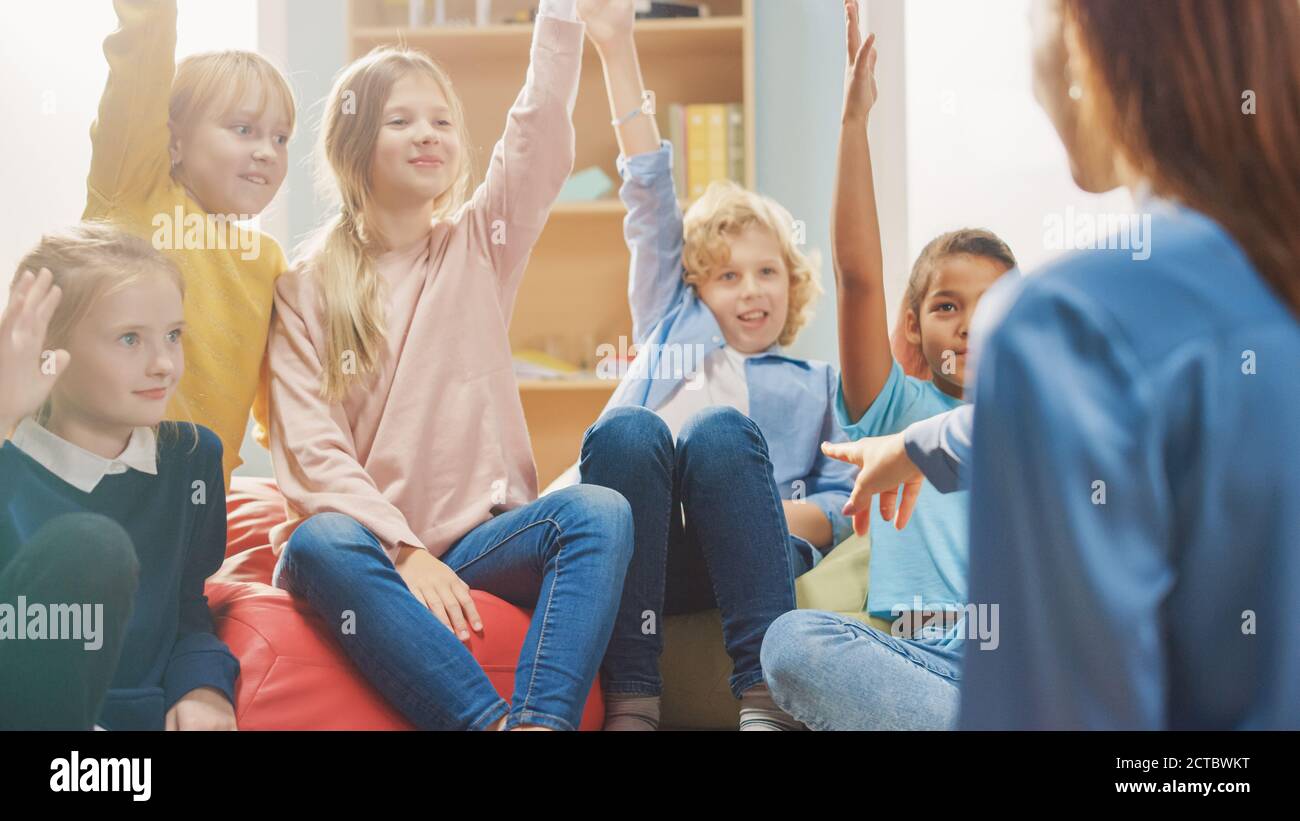 Elementary School Creativity Class: Children Sitting on the Bean Bags ...
