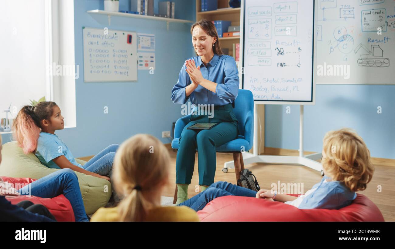 Elementary School Creativity Class: Children Sitting on the Bean Bags ...