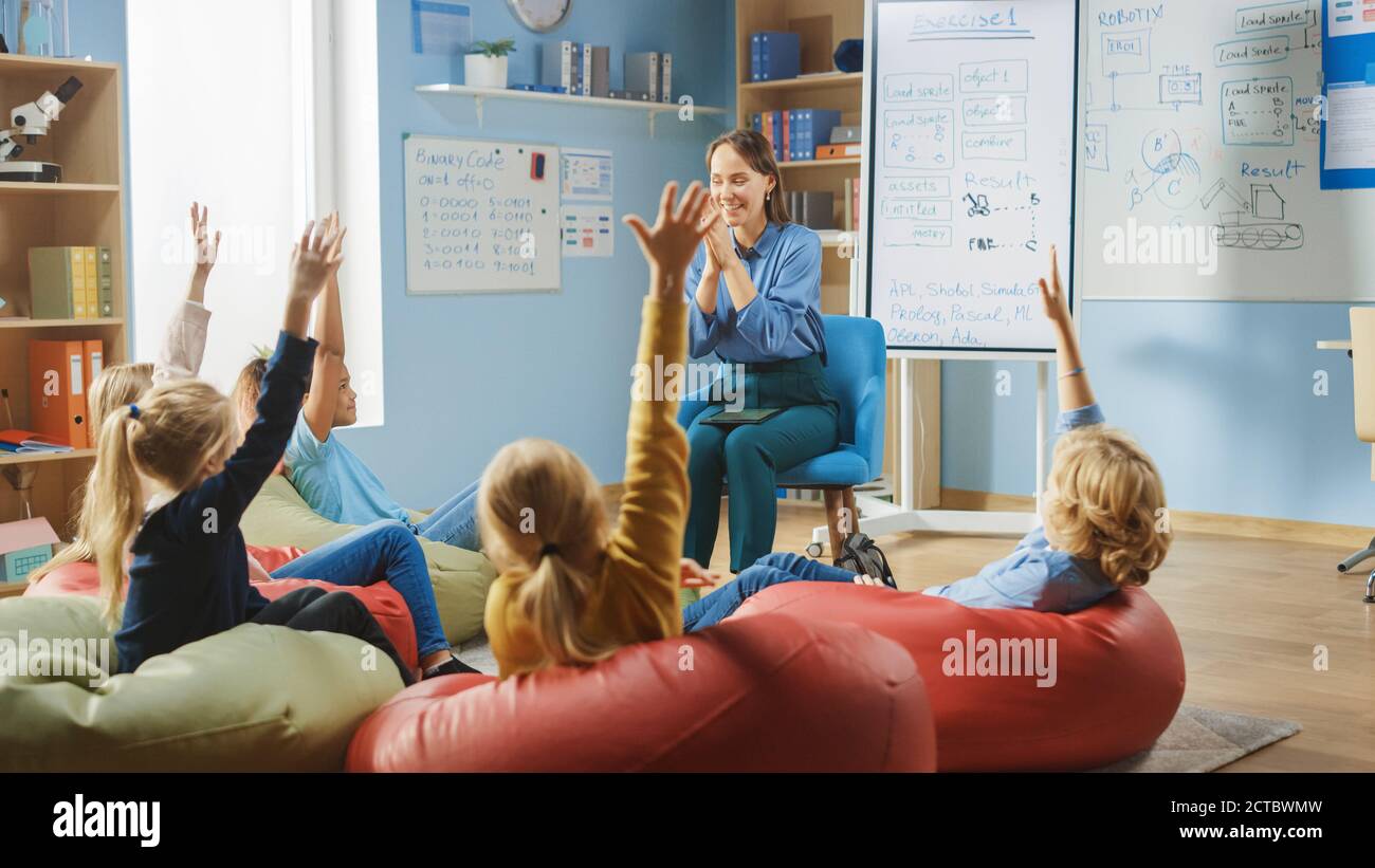 Elementary School Creativity Class: Children Sitting on the Bean Bags ...