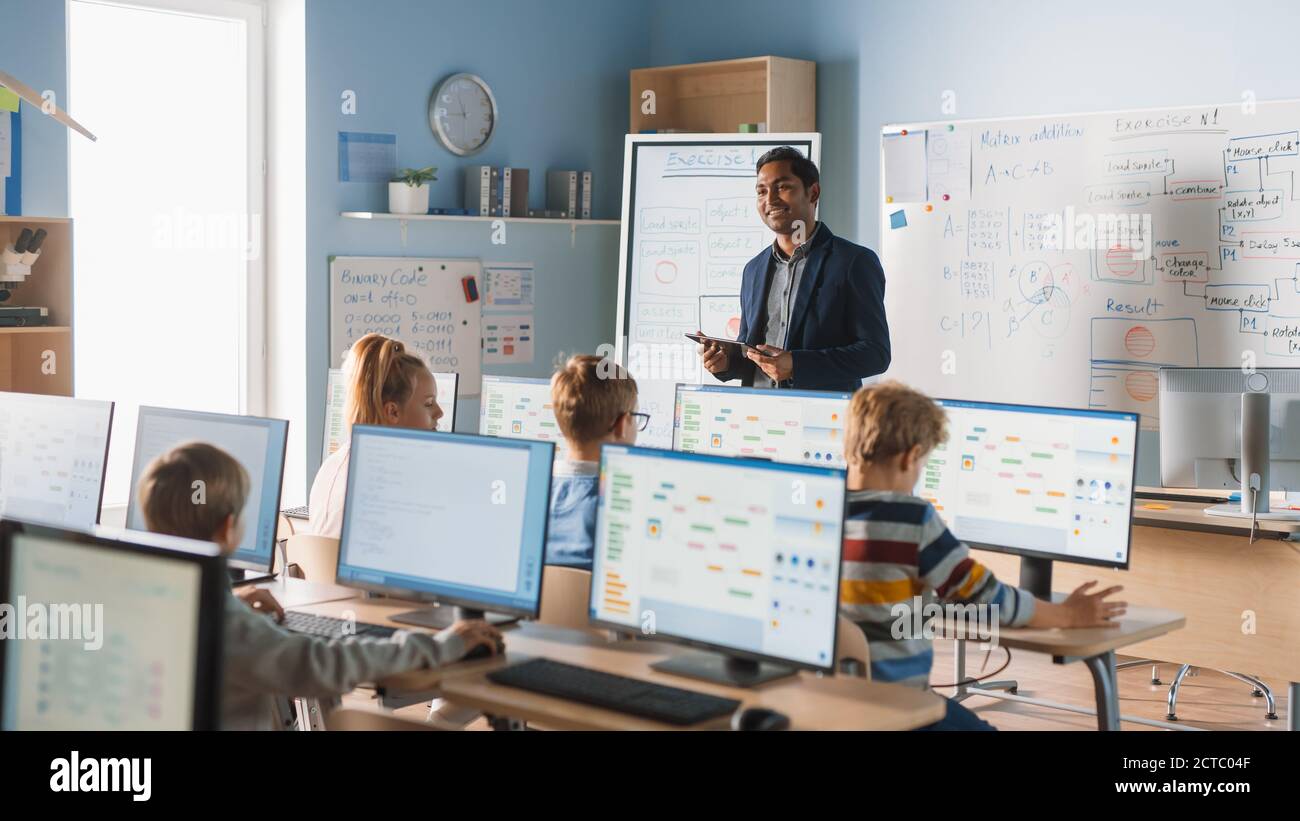 Elementary School Computer Science Class: Teacher Uses Digital Tablet ...