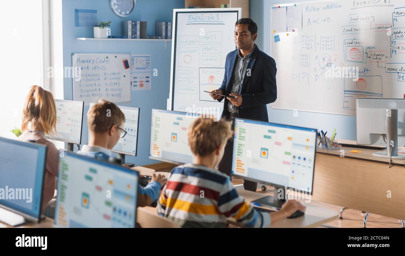 Elementary School Computer Science Class: Teacher Uses Digital Tablet ...