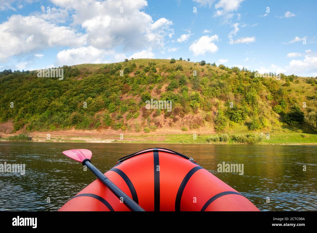 Orange packraft rubber boat on a river. Packrafting. Active lifestile concept Stock Photo