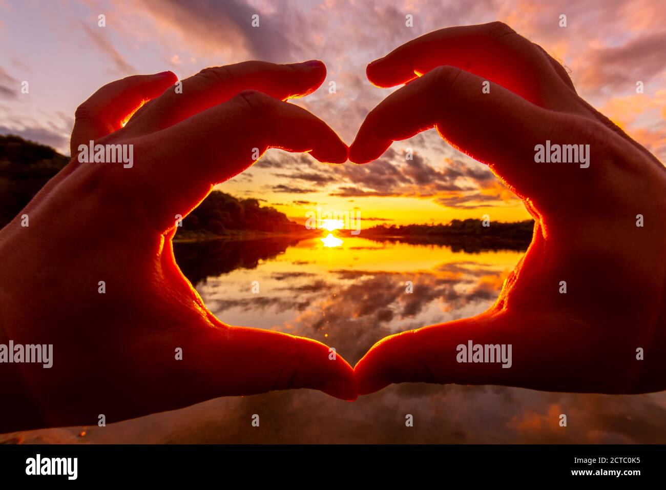 hand heart sunset