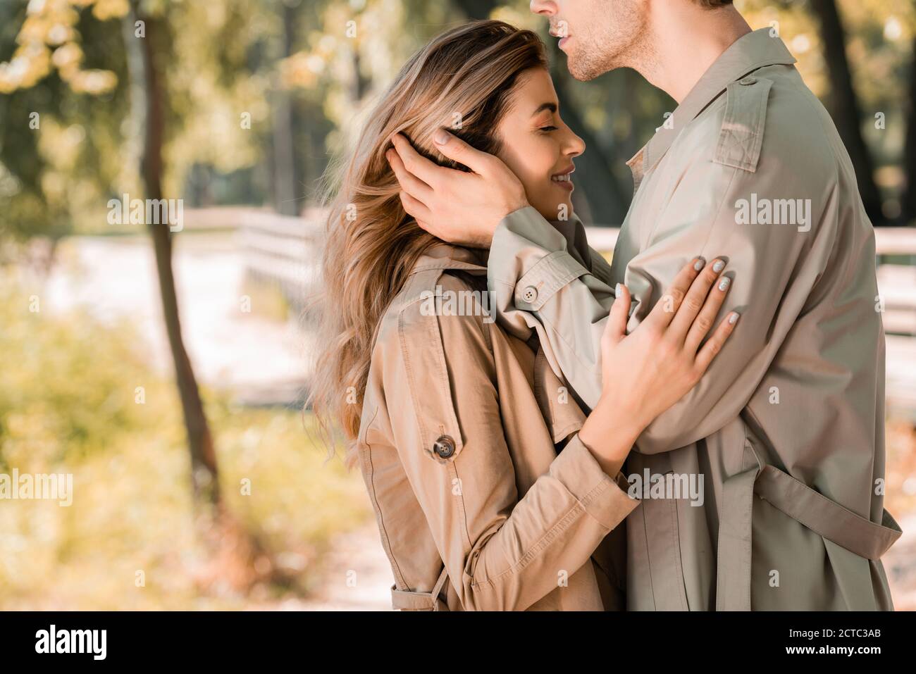 side view of man touching hair of woman with closed eyes outside Stock  Photo - Alamy