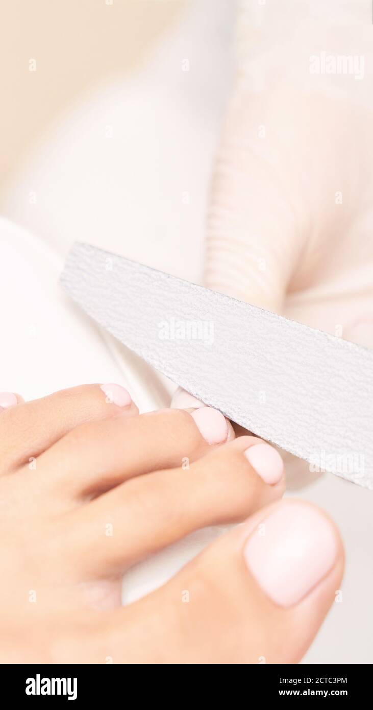 Classic pink wedding toe nail manicure on white backdrop. Spa treatment concept Stock Photo