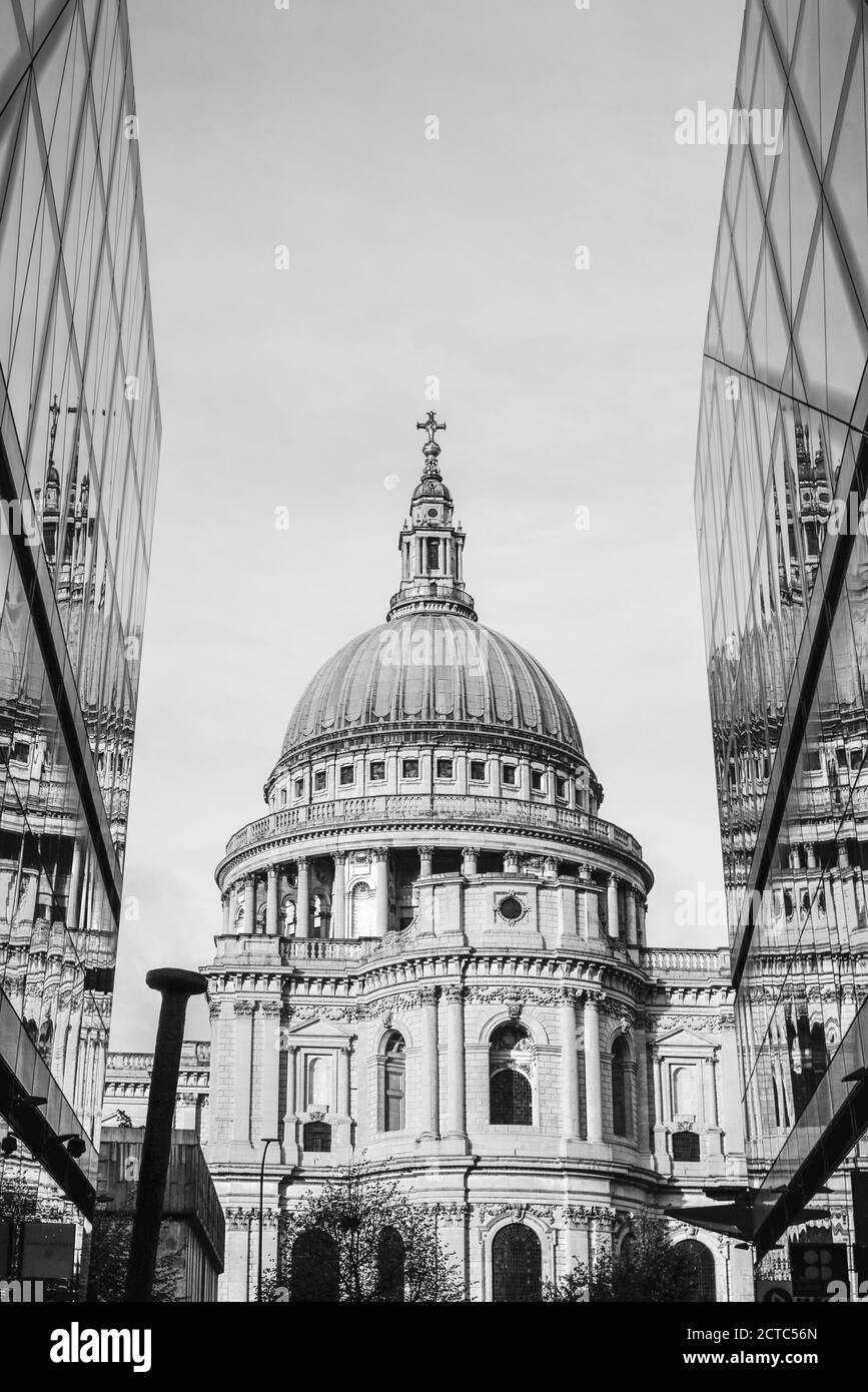 Black and white photo of Saint Paul Cathedral reflected in modern glass walls in City of London, England Stock Photo