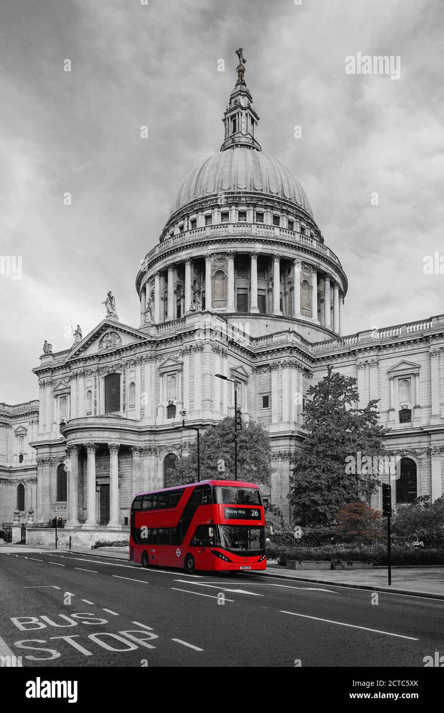 Selective color photo of a modern red bus near Saint Paul Cathedral in the City of London, England Stock Photo