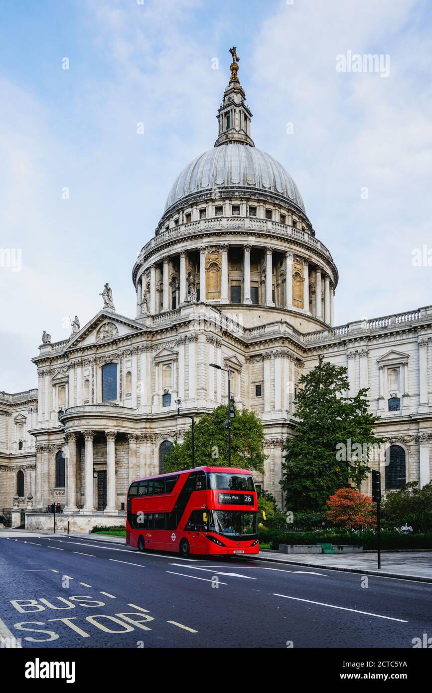Modern red bus in a street near Saint Paul Cathedral in the City of London, England Stock Photo