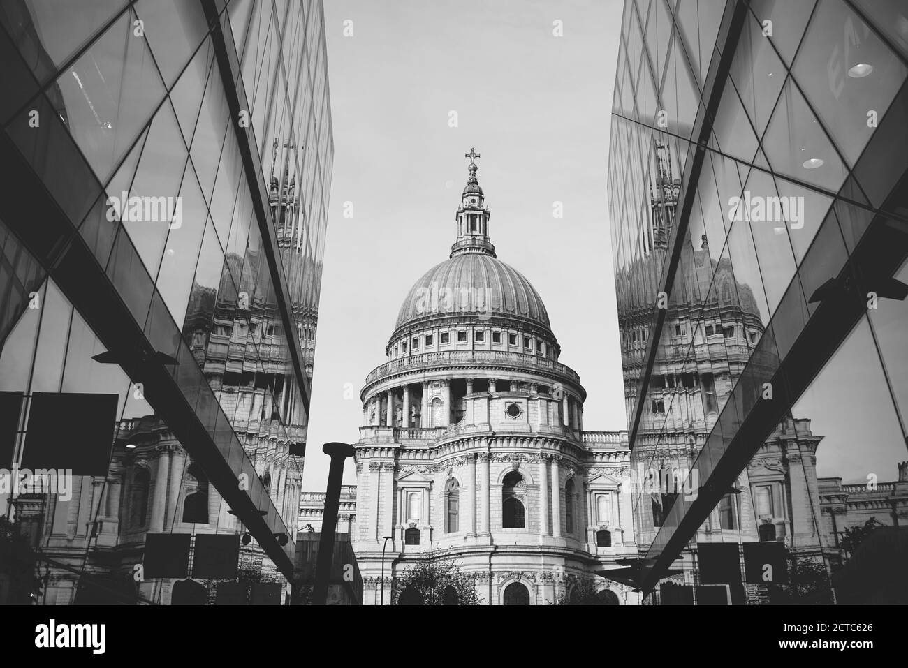 Black and white photo of Saint Paul Cathedral reflected in modern glass walls in City of London, England Stock Photo