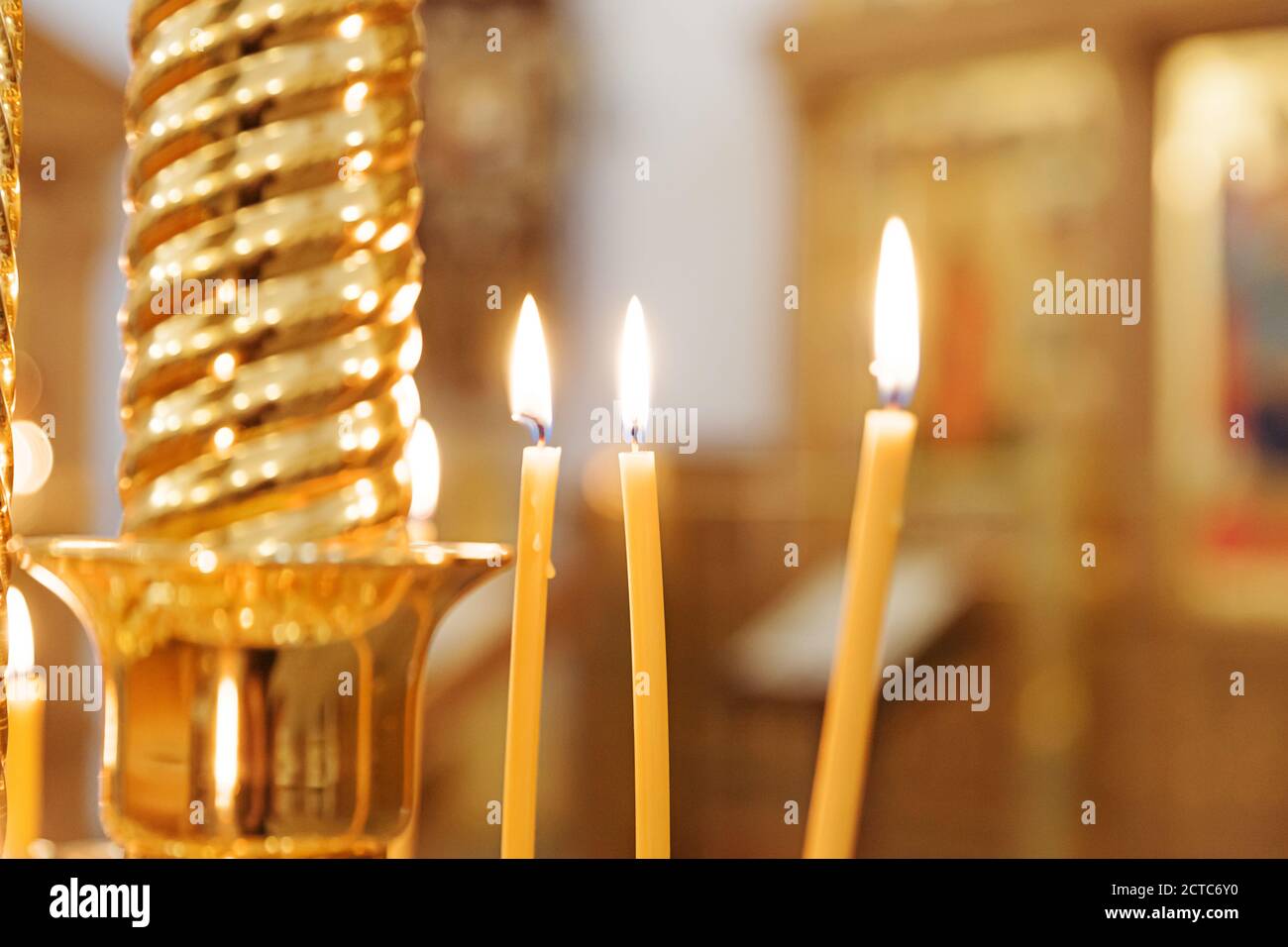 Orthodox Church. Christianity. Festive interior decoration with burning candles and icon in traditional Orthodox Church on Easter Eve or Christmas. Religion faith pray symbol Stock Photo