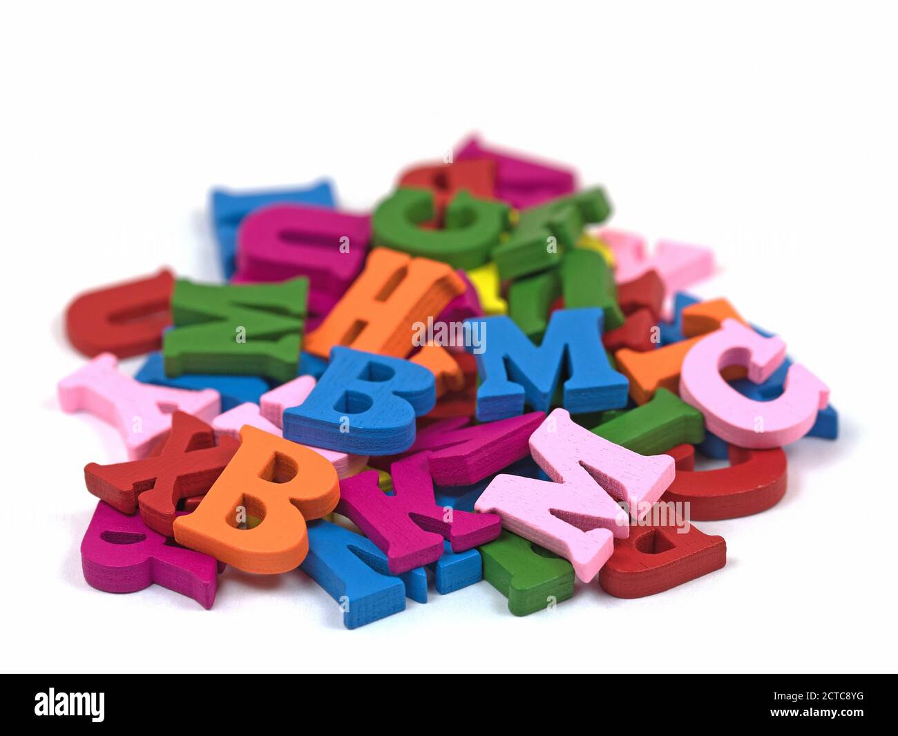 Colorful wooden letters against white background Stock Photo