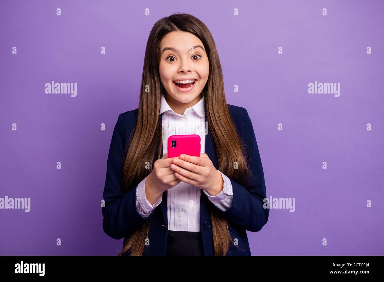 Portrait of her she nice lovely small little cheerful cheery glad long-haired girl using device like smm repost positive feedback isolated bright Stock Photo