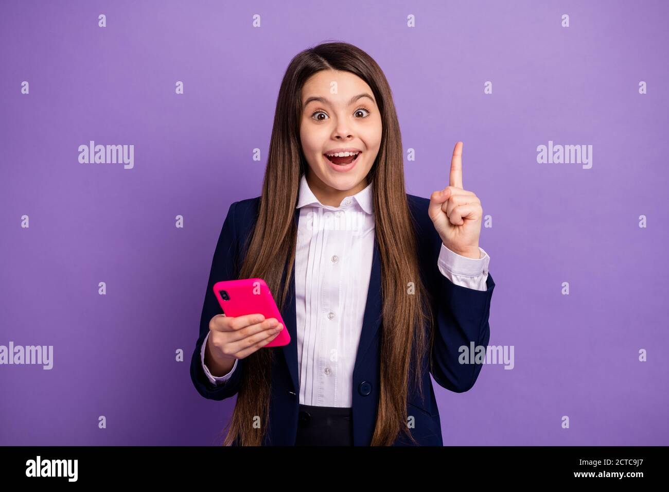 Portrait of her she nice brainy small little cheerful cheery long-haired creative girl using gadget got great idea solution isolated bright vivid Stock Photo