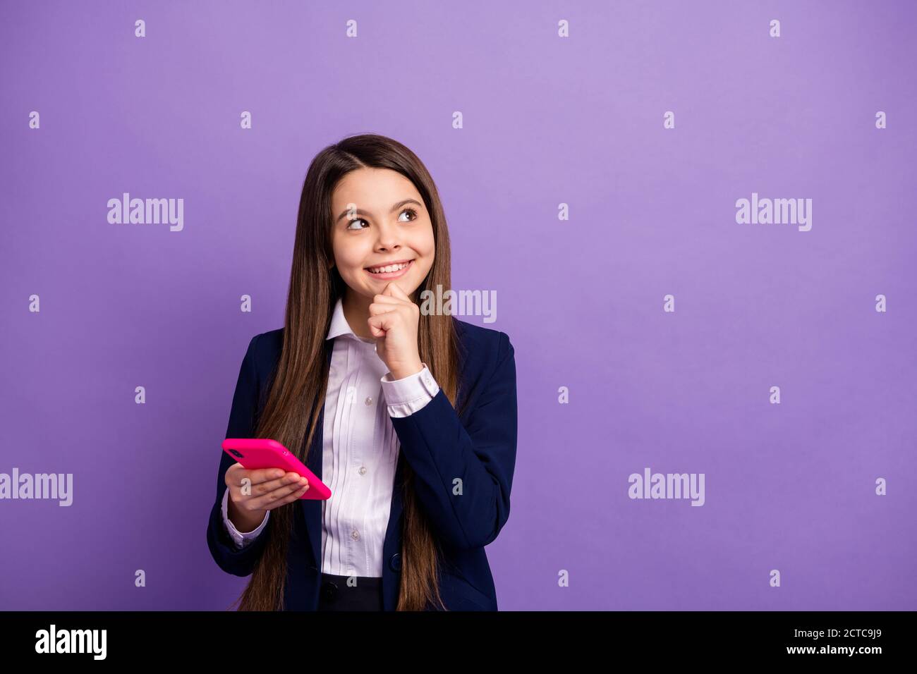Portrait of her she genius brainy small little cheery curious long-haired girl using cell thinking copy space creating strategy smm isolated bright Stock Photo