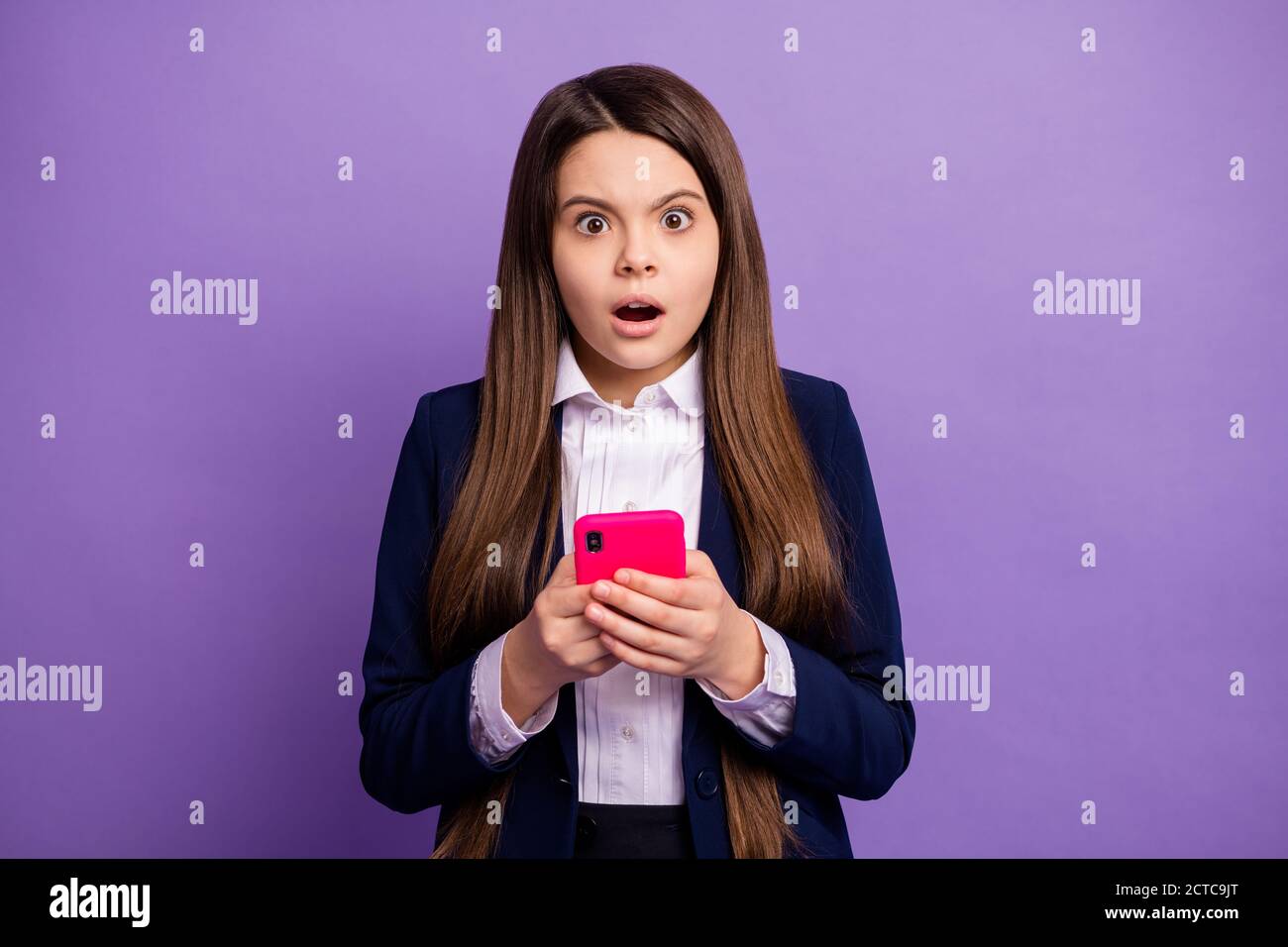 Close-up portrait of her she nice small little displeased long-haired girl using device dislike smm negative comment reaction feedback isolated bright Stock Photo