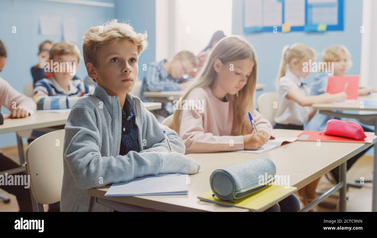 Elementary Classroom of Diverse Children Listening Attentively to their ...
