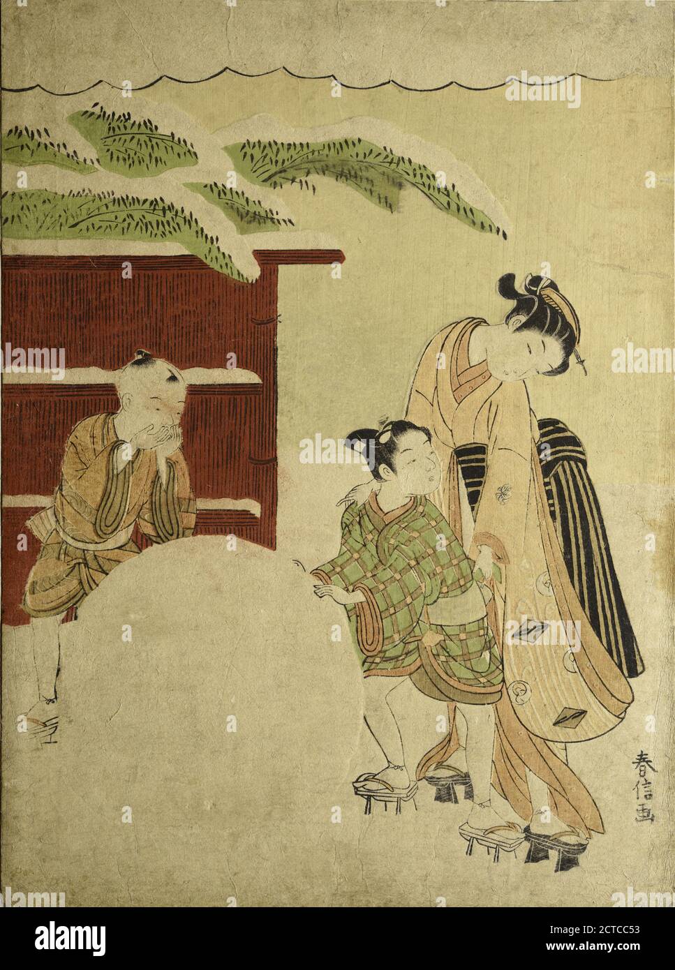 Two boys rolling a large snowball.  A woman standing behind one of them adjusting his clothing.  In the background a straw fence  and snow-laden bamboo branches, still image, Prints, 1766 Stock Photo