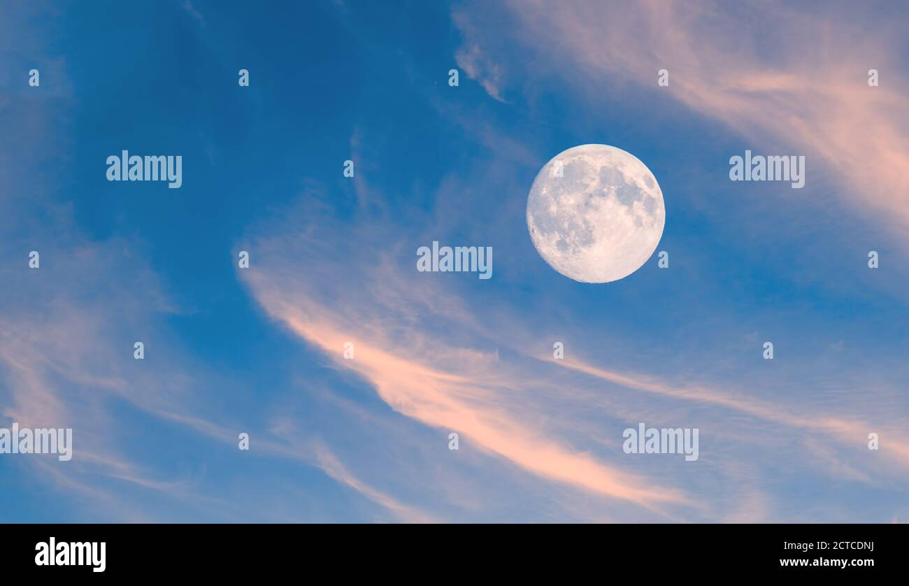 Moon over clouds as nature background. Stock Photo