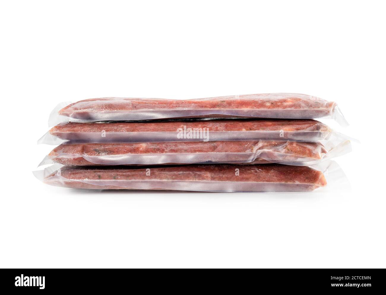 Multiple frozen meat packages in a pile, vacuum sealed. Ground chicken inclusive backs, necks, liver and heart. Concept for raw food diet for pets. Stock Photo