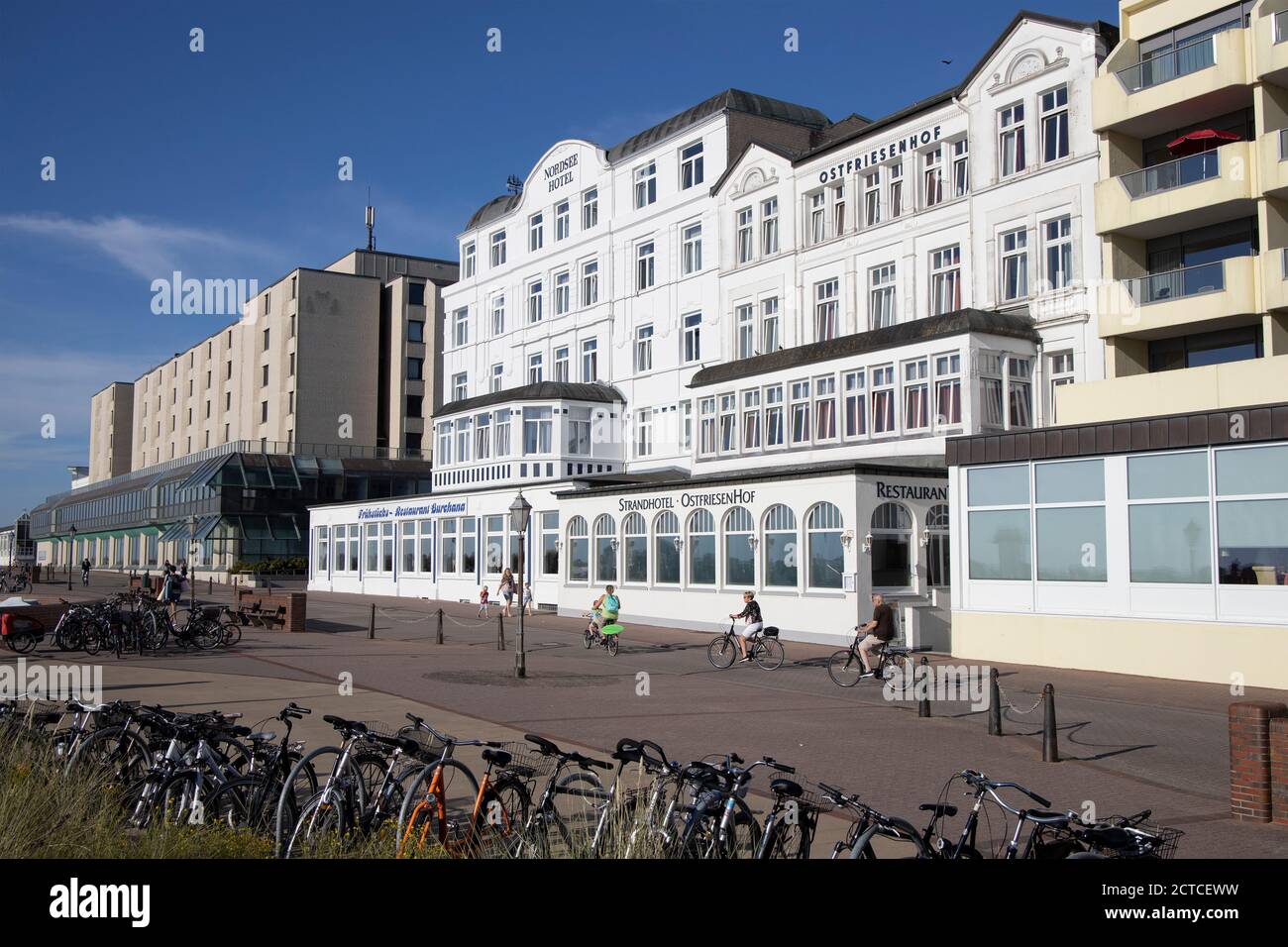 Only a few cyclist on the promenade during the Corona pandemic on Borkum Island, Lower Saxony, Germany, Europe. Stock Photo