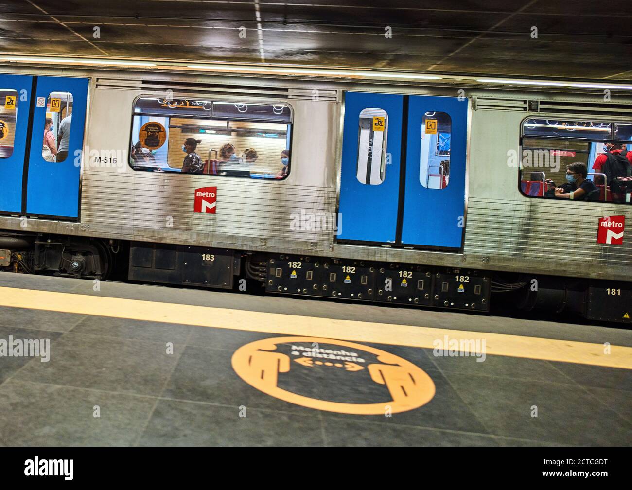 Lisbon, Lissabon, Portugal, 16rd August 2020.  Underground train with passengers and a corona sign with advice to keep distance. © Peter Schatz / Alamy Stock Photos Stock Photo