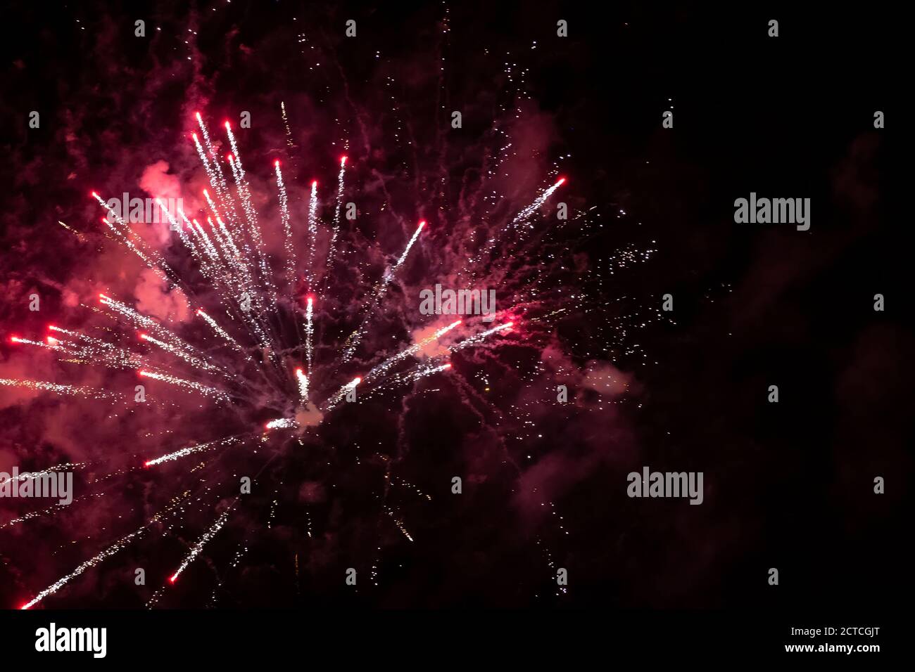 Festive background explosion of fireworks and red smoke. Stock Photo