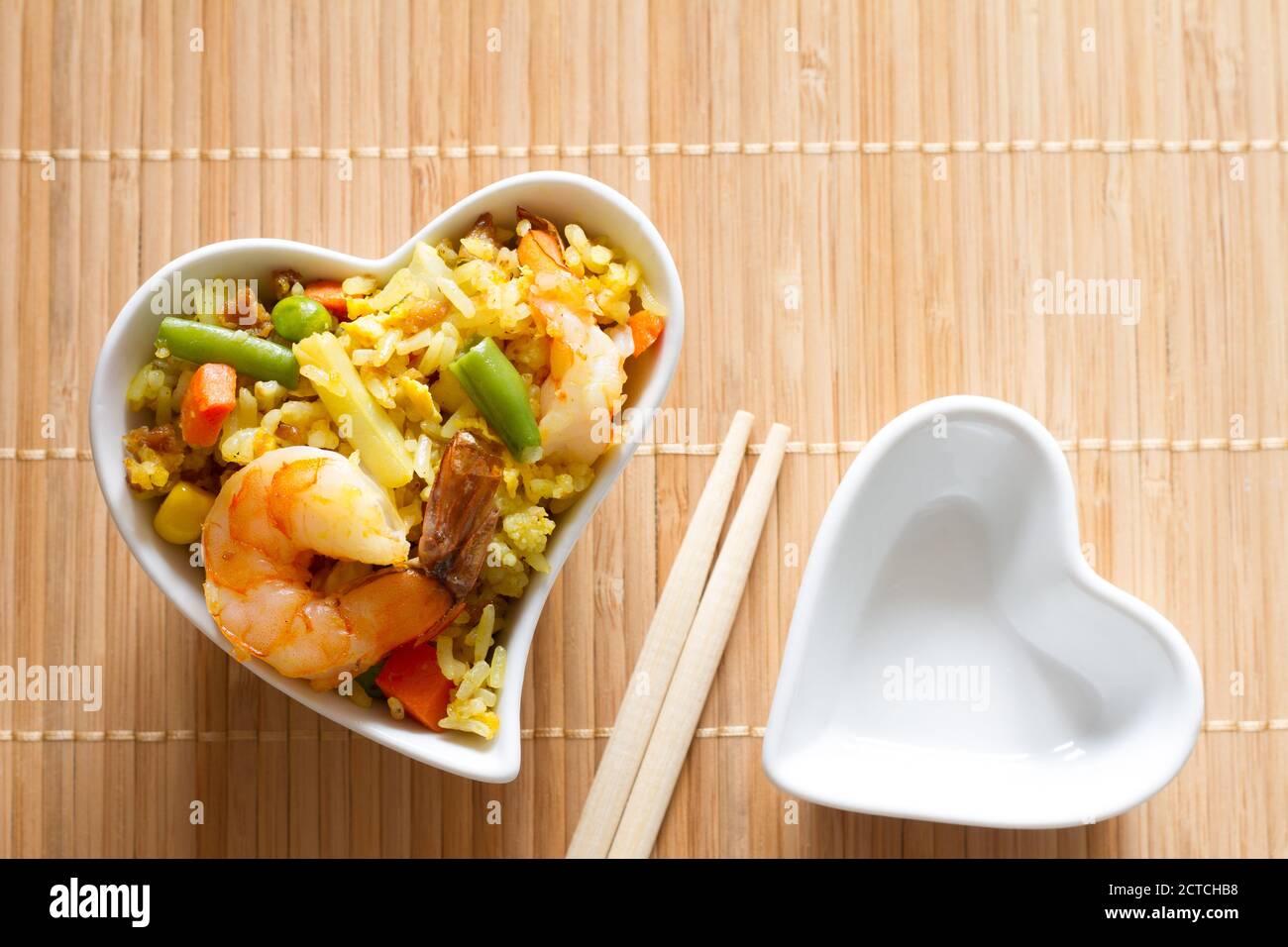 Asian dish in heart-shaped bowl, love asian food menu concept Stock Photo