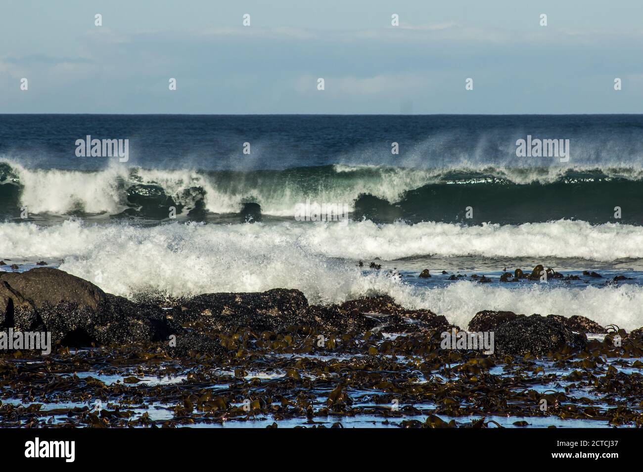 Large waves at the coast of the Namaqua National Park, on the West Coast of South Africa, on a windy day blowing the spray in the opposite direction, Stock Photo