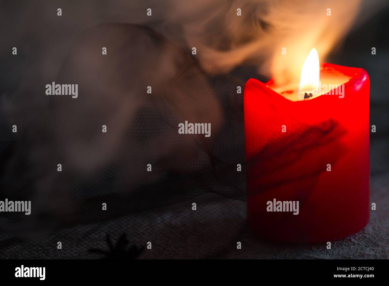 Burning candle, dark, disturbing background, smoke. Halloween concept Stock Photo