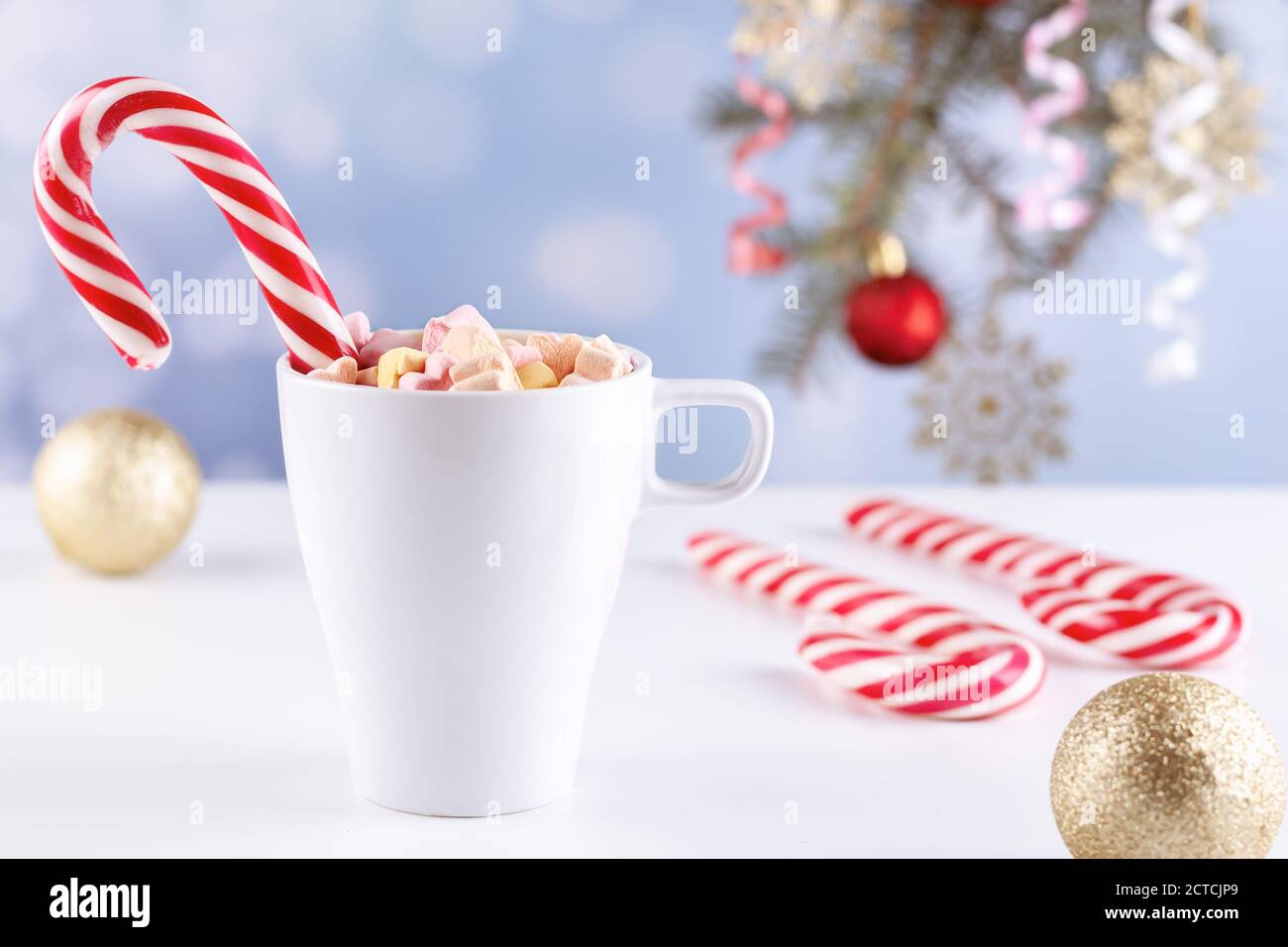 marshmallows and a cup of latte on a white table Stock Photo