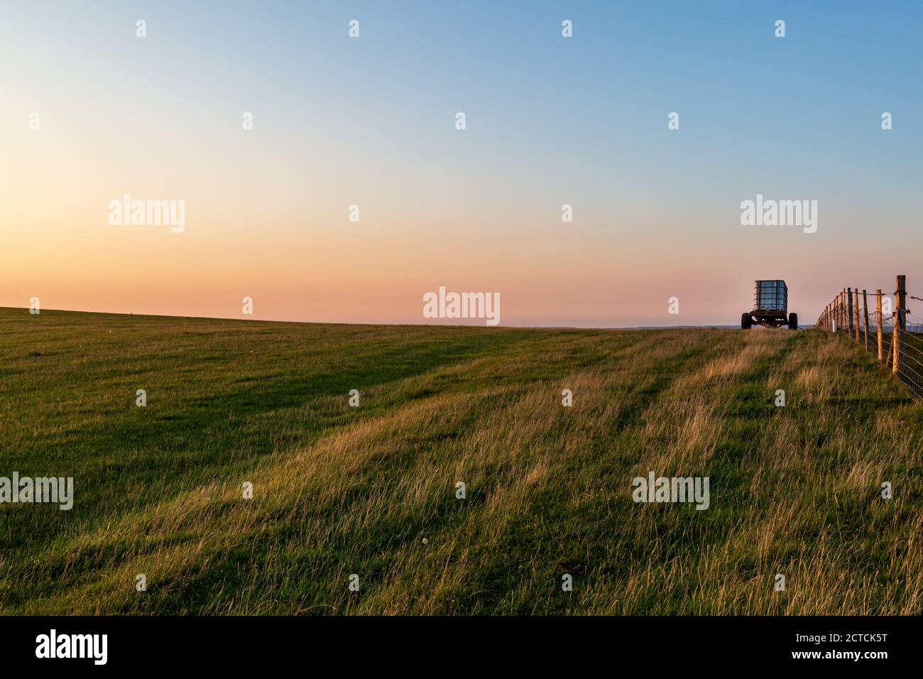A view over farmland on Firle Beacon at sunset Stock Photo