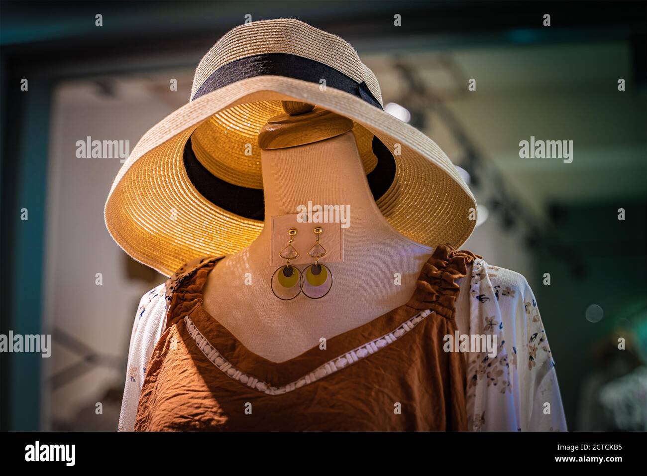 A model without head wearing new dress and a hat at a dress store in Tainan street. Stock Photo