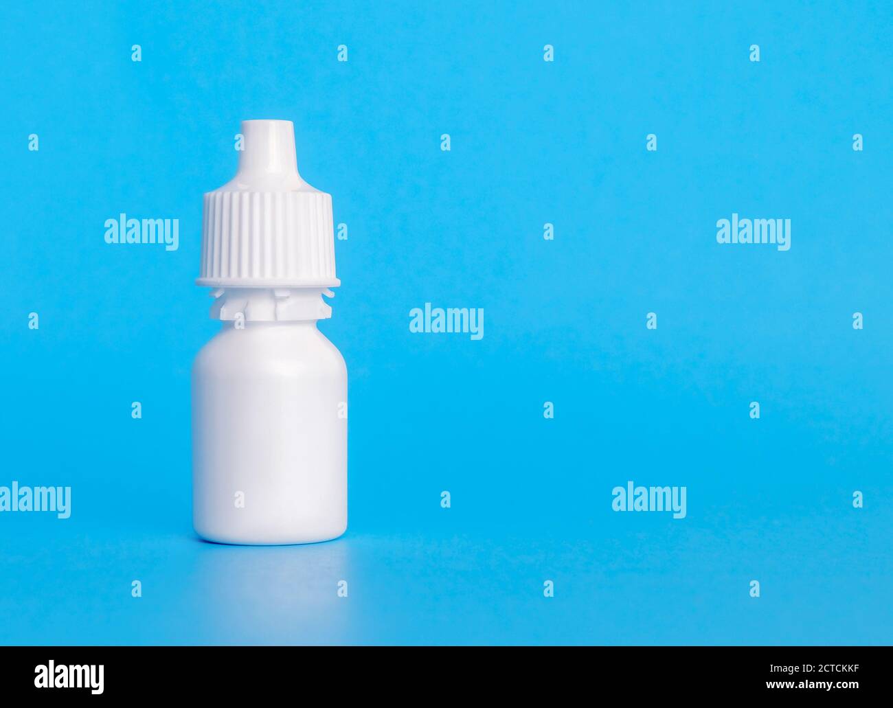 Eye drop bottle, plain, 20 ml. Single white small plastic dropper bottle. With plastic screw top. Used to dispense and store liquids. For medical trea Stock Photo