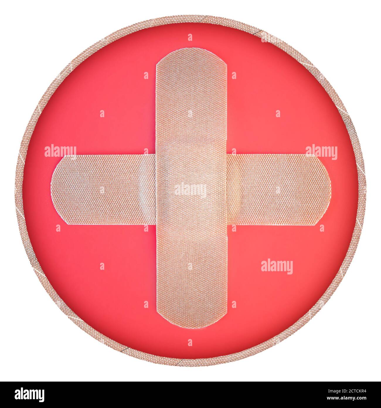 Real fabric bandaid / bandages in shape of a medical plus sign. Round icon. Symbol for: Hospital, emergency, first aid, medical or health. Stock Photo
