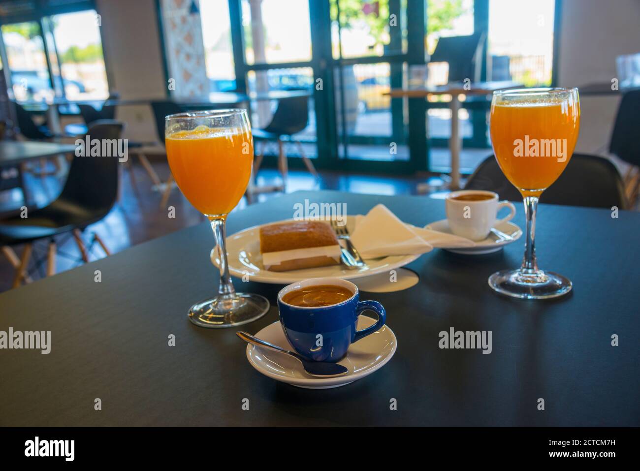 Orange juice, cups of coffee and sobao pasiego in a cafeteria. Spain. Stock Photo