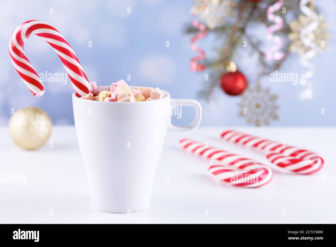 marshmallows and a cup of latte on a white table Stock Photo