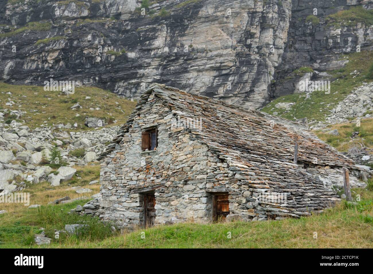 Traditional farmhouse built from boulders found on site, Schwarzi Balma, Wallis, Switzerland Stock Photo